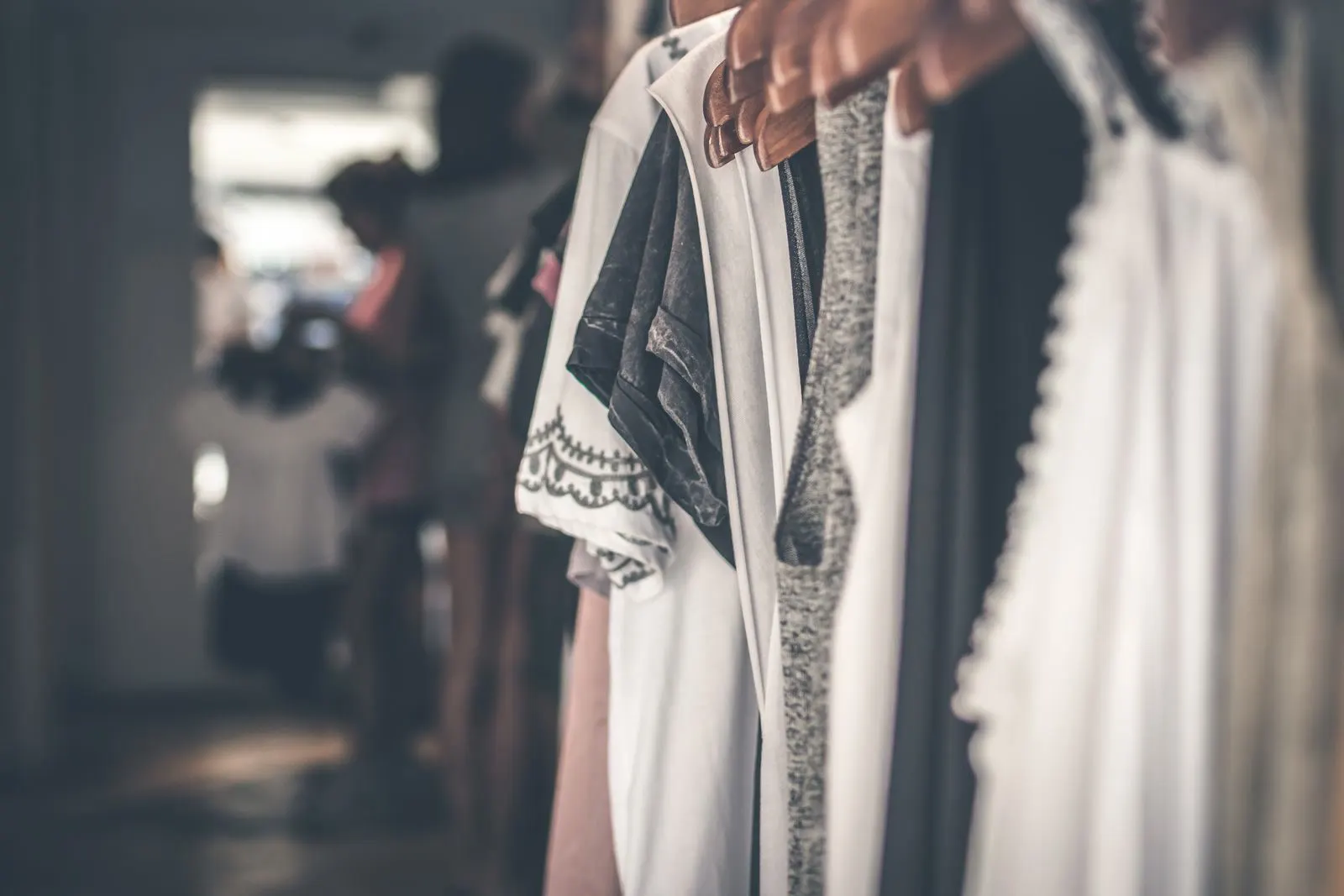 A rail of neutral separates and dresses in a considered wardrobe palette